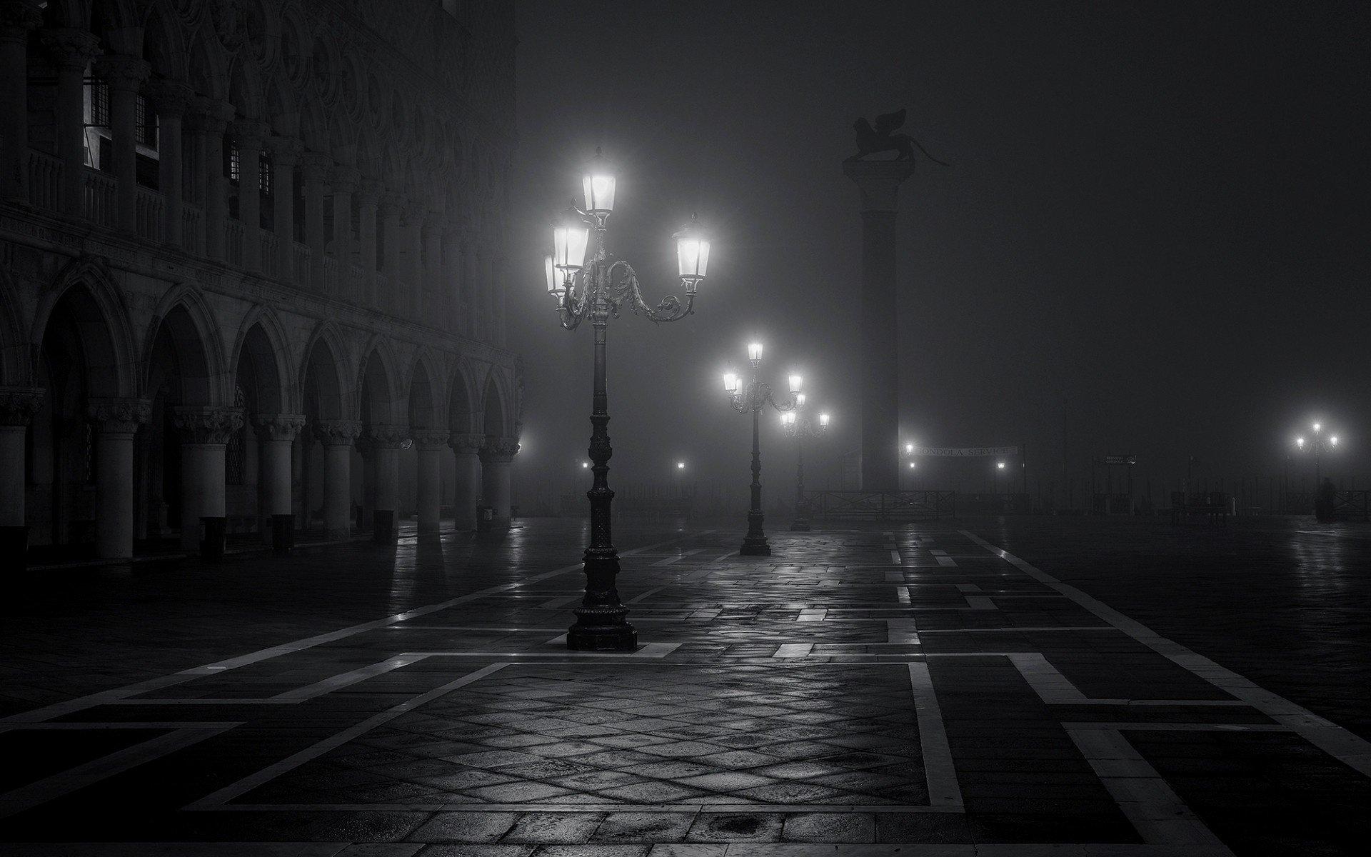 Black and white image of a dark street.