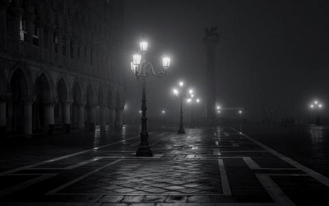 Black and white image of dark street.