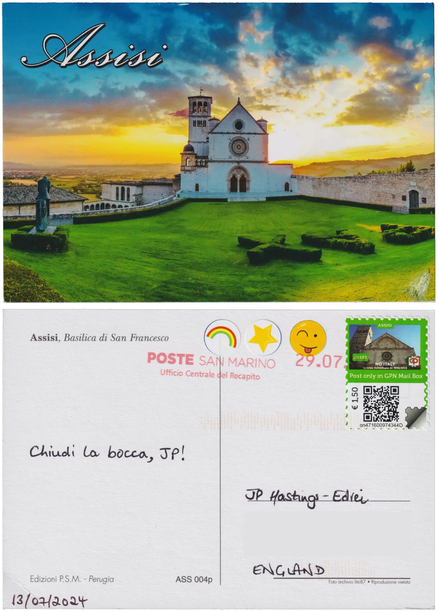 Both sides of a postcard. On the front: The Papal Basilica of Saint Francis in Assisi, golden sunset behind its white brickwork, green garden in front. On the back: Chiudi la bocca, JP!
