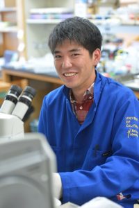 Student sitting at microscope