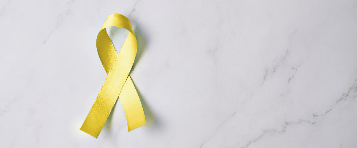 Yellow ribbon on a white marble background symbolizing employee assistance support.
